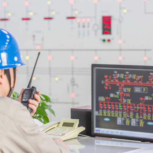 workers in control room of a factory.